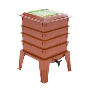 Photo of terra cotta colored plastic worm bin with 4 stacking bins, a top, and pedestal, with front liquid drain