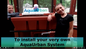 Photo of children posing after installing the AquaUrban system.