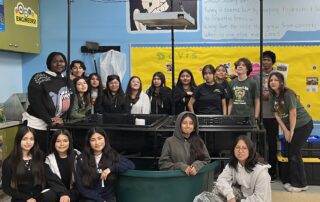 Harmony Aquaponic System With Students standing around the system